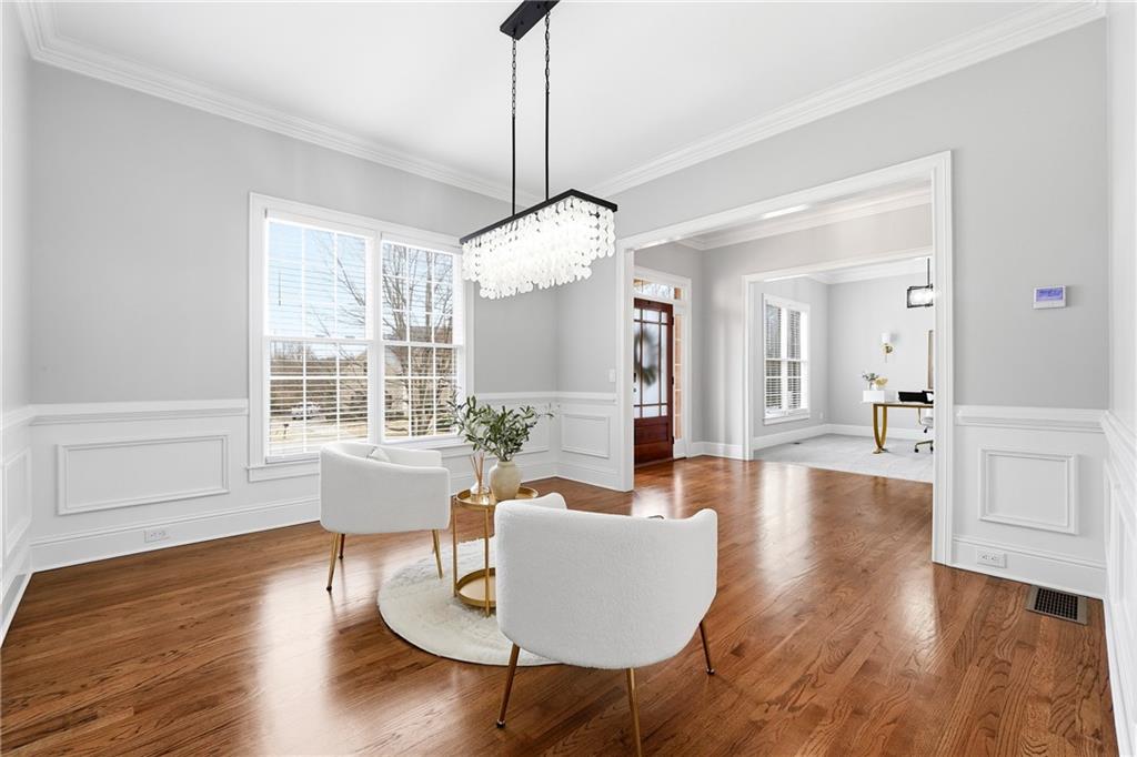 2555 Weddington Ridge Northeast Marietta, GA 30068 - Photo 11 of 65 a living room with couches chairs and kitchen view with wooden floor