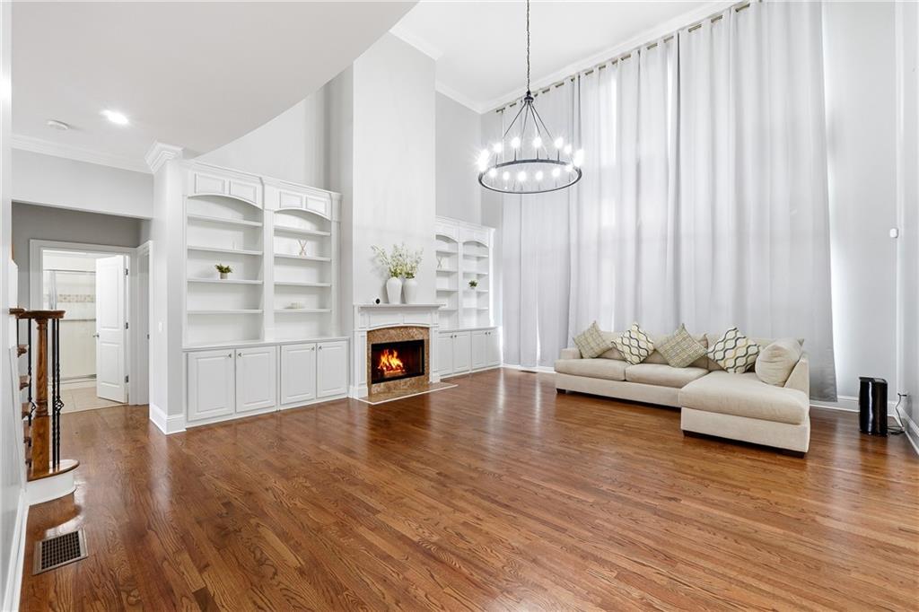 2555 Weddington Ridge Northeast Marietta, GA 30068 - Photo 13 of 65 a view of a livingroom with furniture wooden floor fireplace and windows