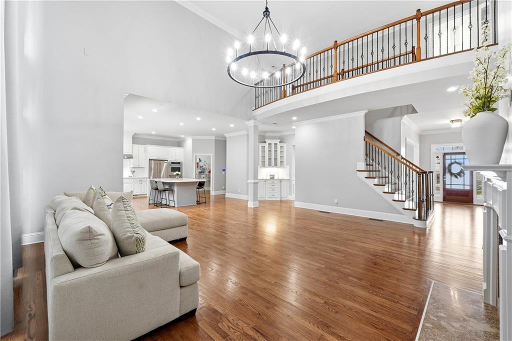 2555 Weddington Ridge Northeast Marietta, GA 30068 - Photo 14 of 65 a view of a living room and kitchen with furniture wooden floor and windows