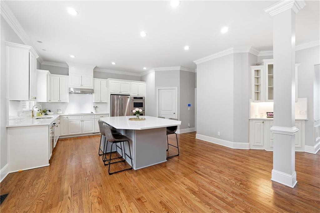 2555 Weddington Ridge Northeast Marietta, GA 30068 - Photo 18 of 65 a kitchen with stainless steel appliances granite countertop a kitchen island hardwood floor sink stove and granite counter top