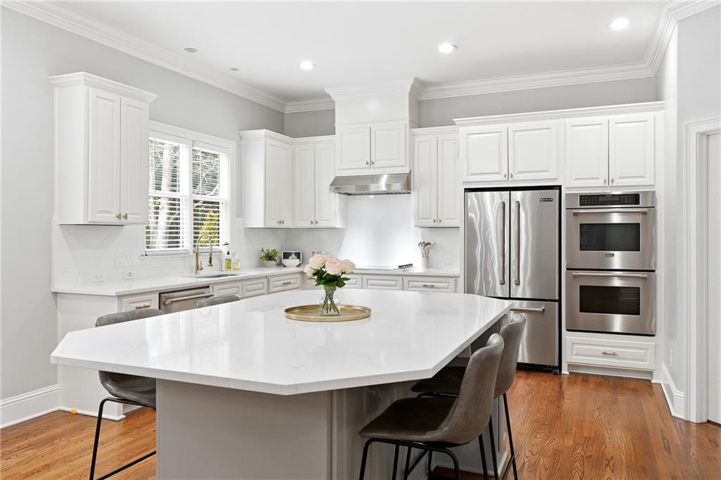 2555 Weddington Ridge Northeast Marietta, GA 30068 - Photo 20 of 65 a kitchen with refrigerator a sink and chairs