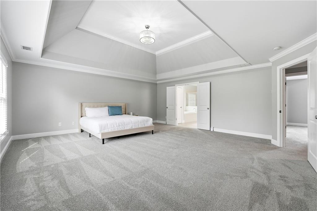 2555 Weddington Ridge Northeast Marietta, GA 30068 - Photo 24 of 65 a bedroom with a bed and a lamp