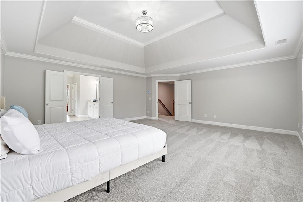 2555 Weddington Ridge Northeast Marietta, GA 30068 - Photo 25 of 65 a spacious bedroom with a bed and a cabinets