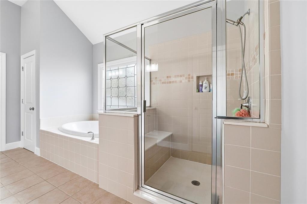2555 Weddington Ridge Northeast Marietta, GA 30068 - Photo 30 of 65 a bathroom with a bathtub and a shower
