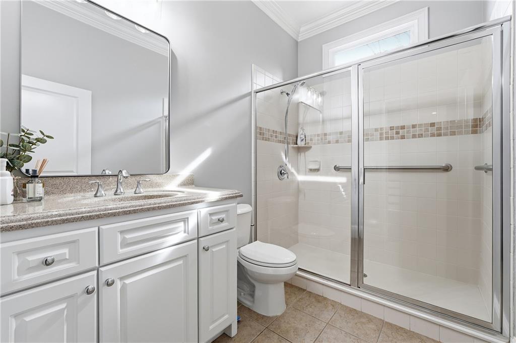 2555 Weddington Ridge Northeast Marietta, GA 30068 - Photo 35 of 65 a bathroom with a shower sink vanity mirror and toilet