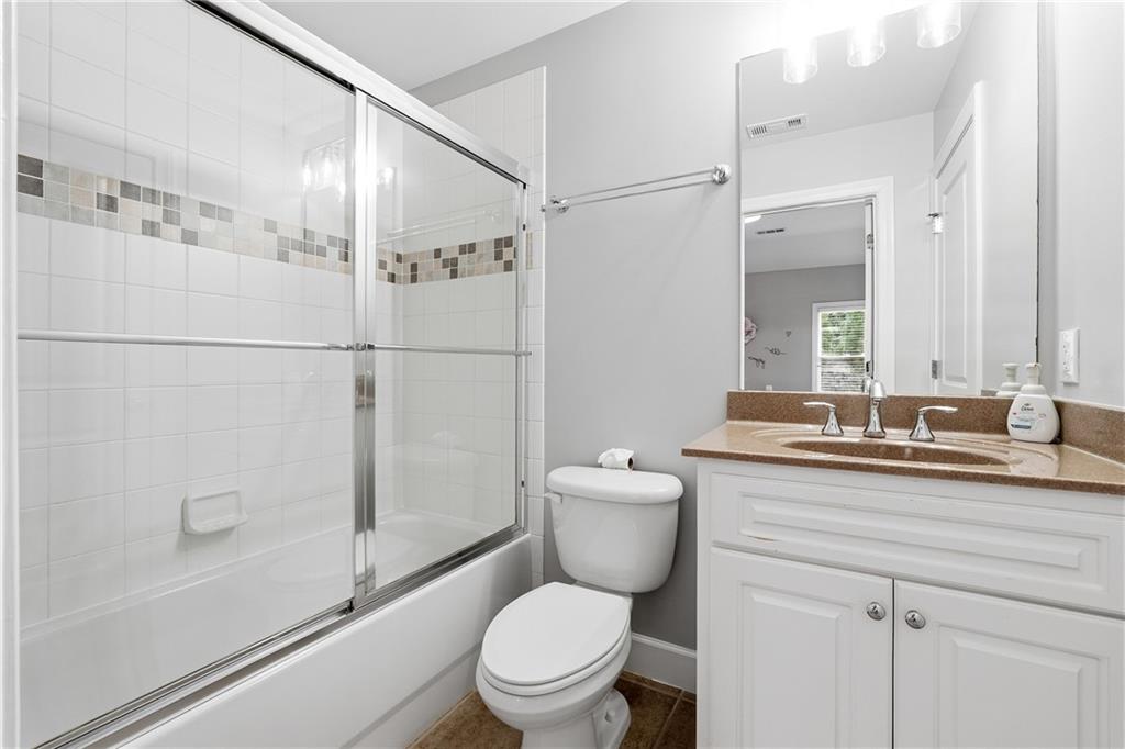 2555 Weddington Ridge Northeast Marietta, GA 30068 - Photo 40 of 65 a bathroom with a granite countertop sink toilet and shower