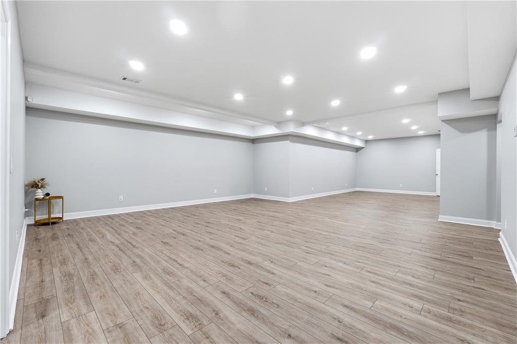 2555 Weddington Ridge Northeast Marietta, GA 30068 - Photo 47 of 65 an empty room with wooden floor and windows