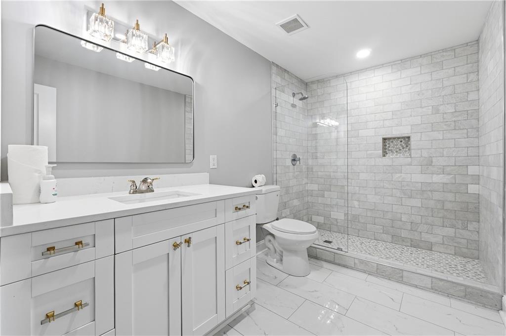 2555 Weddington Ridge Northeast Marietta, GA 30068 - Photo 52 of 65 a bathroom with a double vanity sink mirror and toilet