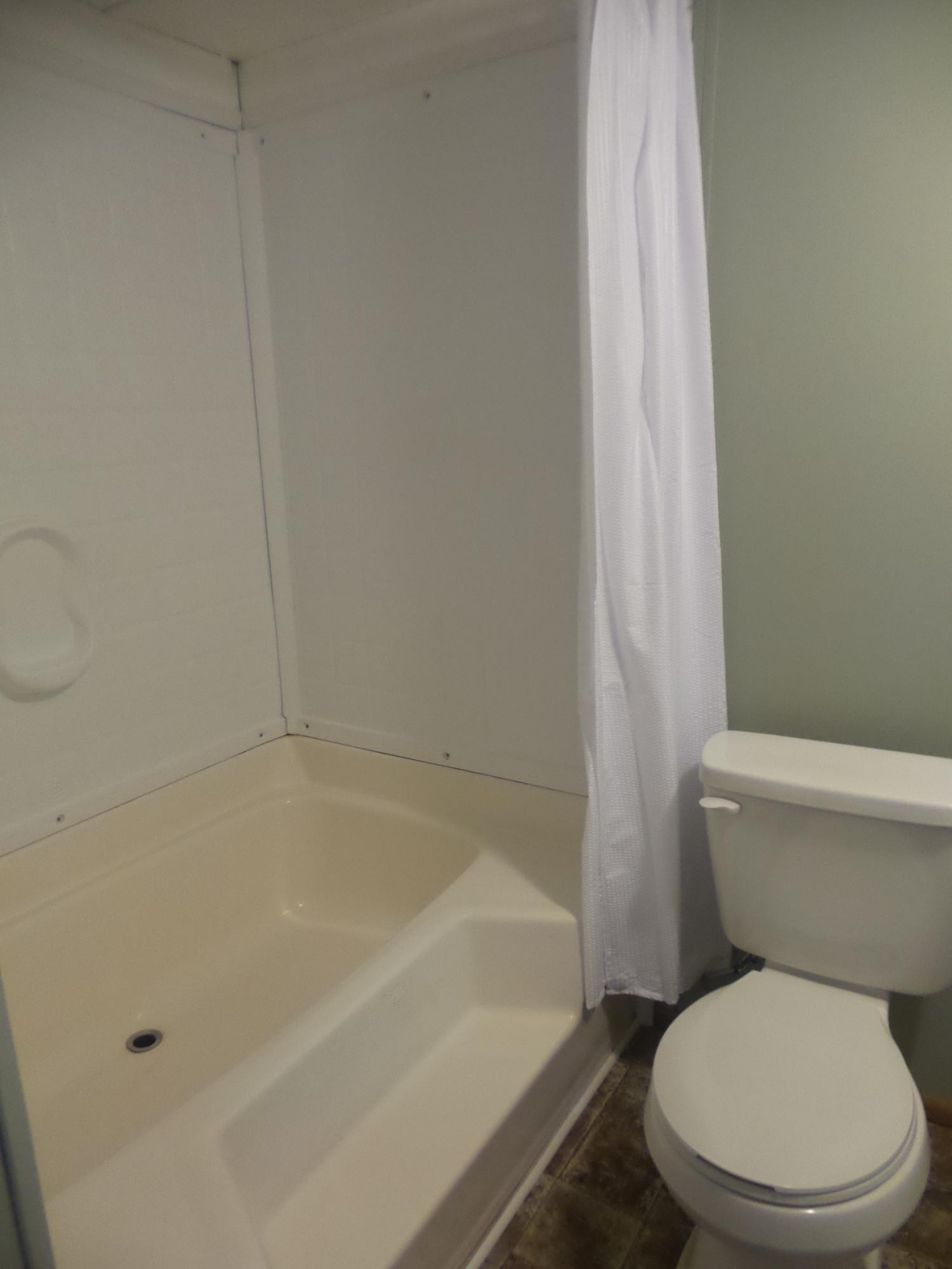 386 Ideal Valley Road Spring City, TN 37381 - Photo 6 of 12 a white toilet sitting next to a bath tub