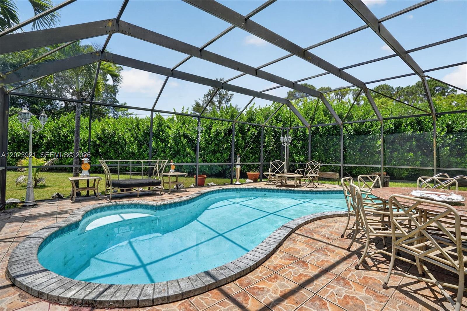 8461 Southwest 68th St Road Miami, FL 33143 - Photo 14 of 65 a view of a swimming pool with a sitting space
