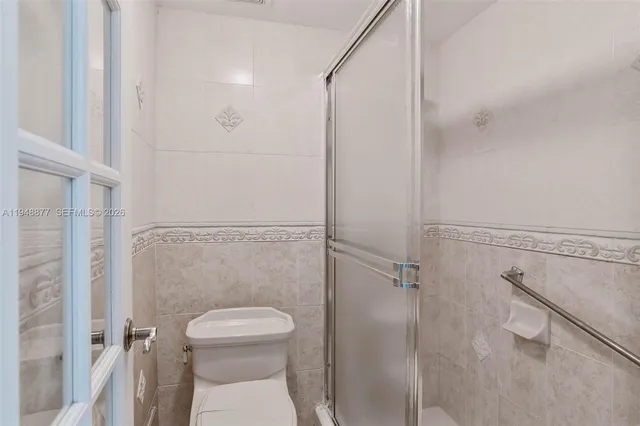 a bathroom with a toilet a sink and shower