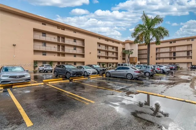a view of building with cars parked