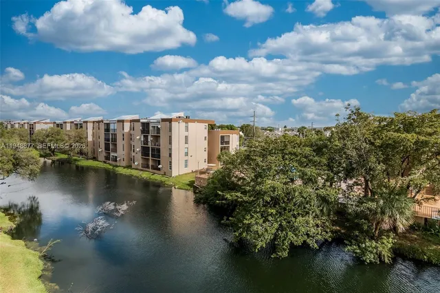 a view of a lake with houses in back