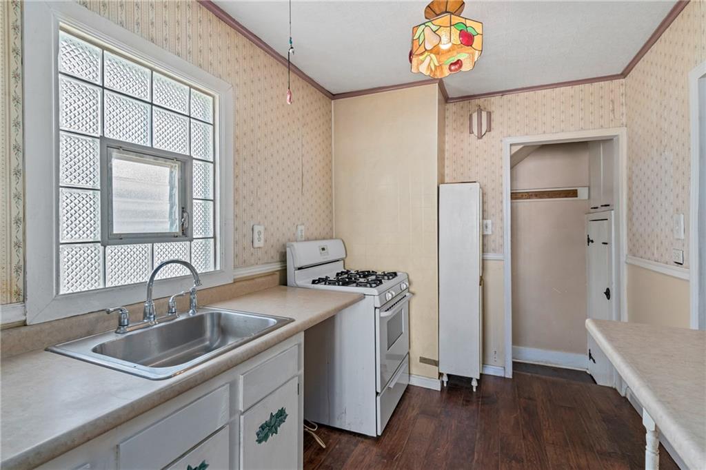 214 Sarah Street McKees Rocks, PA 15136 - Photo 11 of 28 a kitchen with a sink cabinets and wooden floor