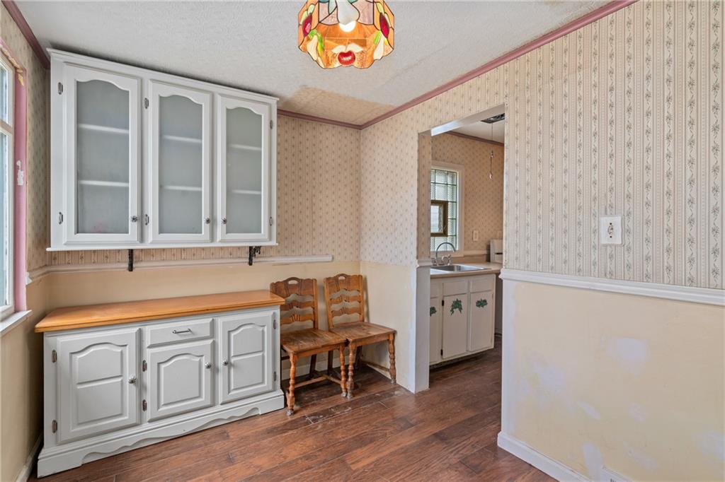 214 Sarah Street McKees Rocks, PA 15136 - Photo 13 of 28 a hallway with cabinets and wooden floor