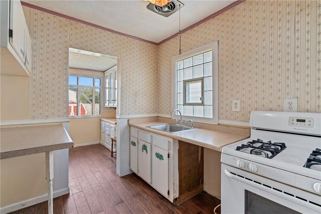 214 Sarah Street McKees Rocks, PA 15136 - Photo 10 of 28 a kitchen with a stove and a refrigerator