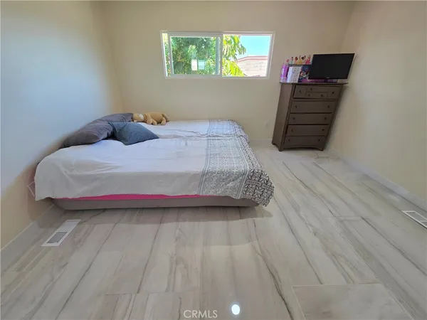 a bedroom with a bed and a window