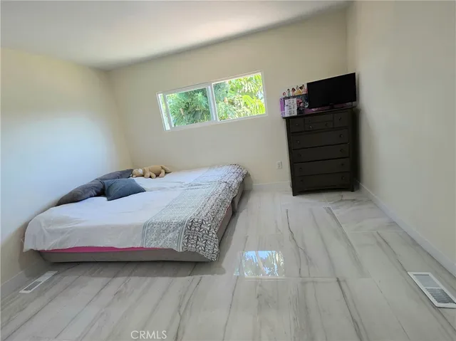 a bedroom with a bed and a desk