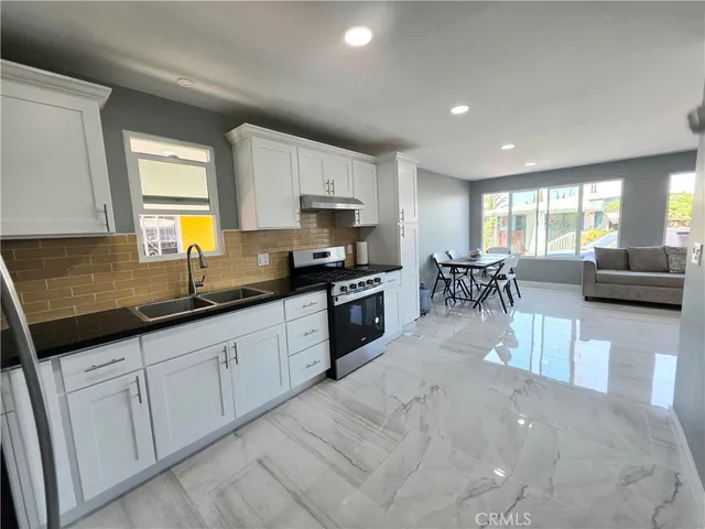 a large kitchen with granite countertop lots of counter top space