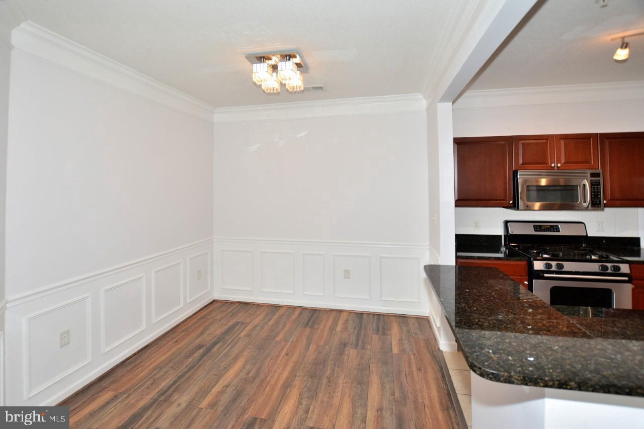 508 Sunset View Terrace Southeast, Unit 205 Leesburg, VA 20175 - Photo 22 of 28 a view of a kitchen with wooden floor and a sink