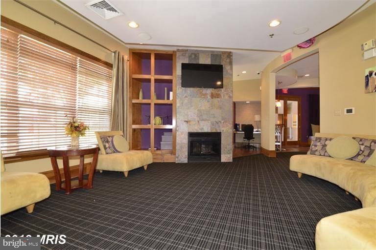 508 Sunset View Terrace Southeast, Unit 205 Leesburg, VA 20175 - Photo 25 of 28 a living room with furniture fireplace and flat screen tv