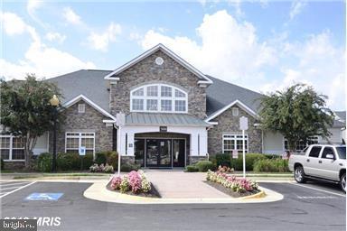 508 Sunset View Terrace Southeast, Unit 205 Leesburg, VA 20175 - Photo 28 of 28 a front view of a house with a yard