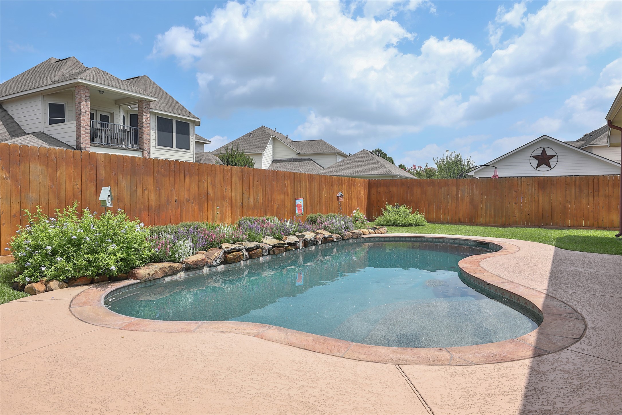 20519 Windrose Bend Drive Spring, TX 77379 - Photo 29 of 37 This backyard is an owner's dream! It features a covered back porch for relaxing, a sparkling pool to cool off in, and an additional covered patio complete with an outdoor kitchen —the perfect spot for entertaining guests or watching the big game.
