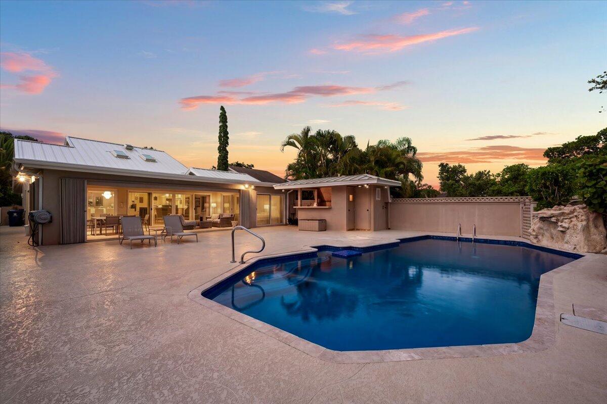 352 River Edge Road Jupiter, FL 33477 - Photo 43 of 56 a view of a swimming pool with a yard