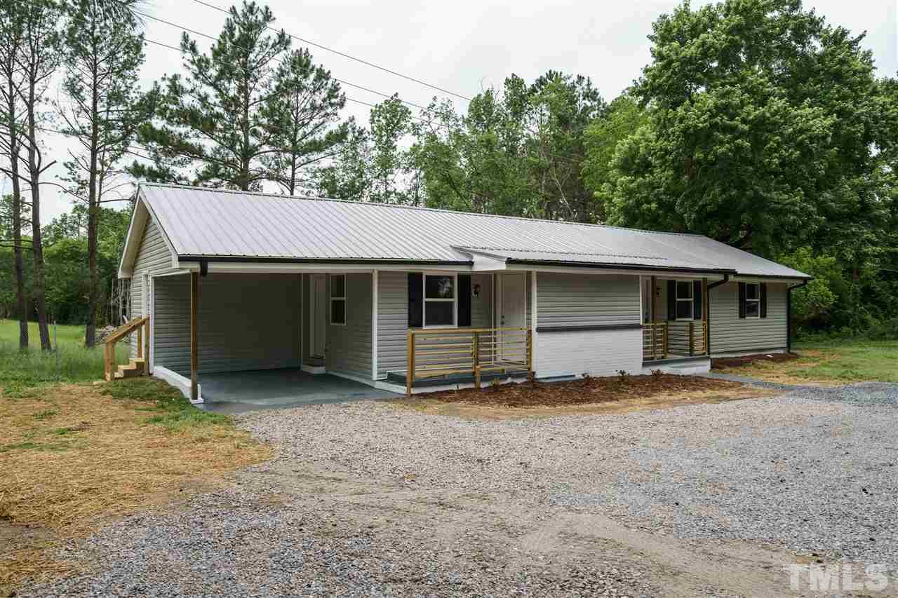1421 Creech Road Garner, NC 27529 - Photo 2 of 23 a view of a house with a yard and large tree