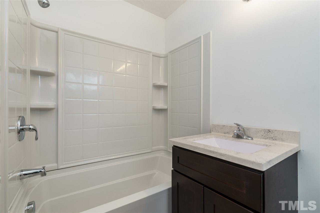 1421 Creech Road Garner, NC 27529 - Photo 12 of 23 a bathroom with a sink and a mirror