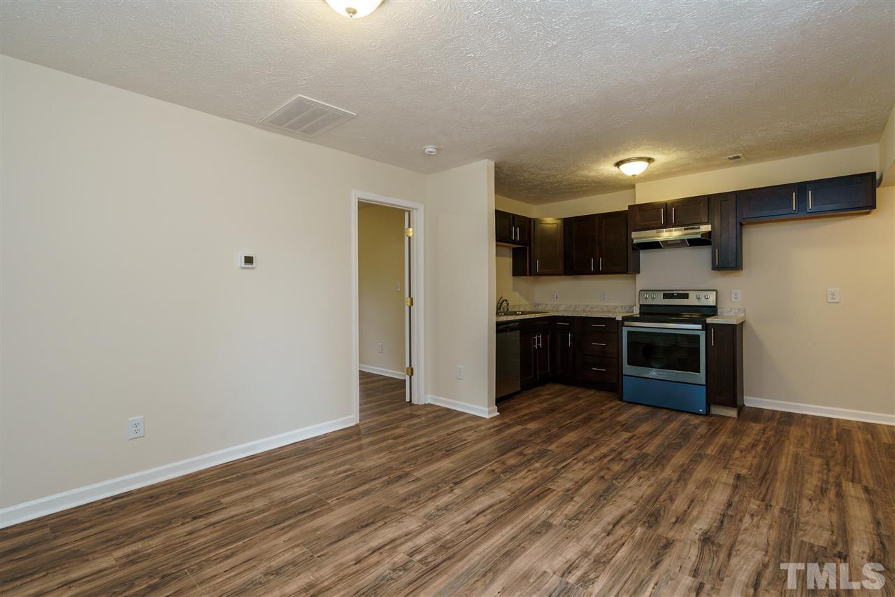 1421 Creech Road Garner, NC 27529 - Photo 17 of 23 a kitchen with stainless steel appliances a refrigerator and a stove top oven
