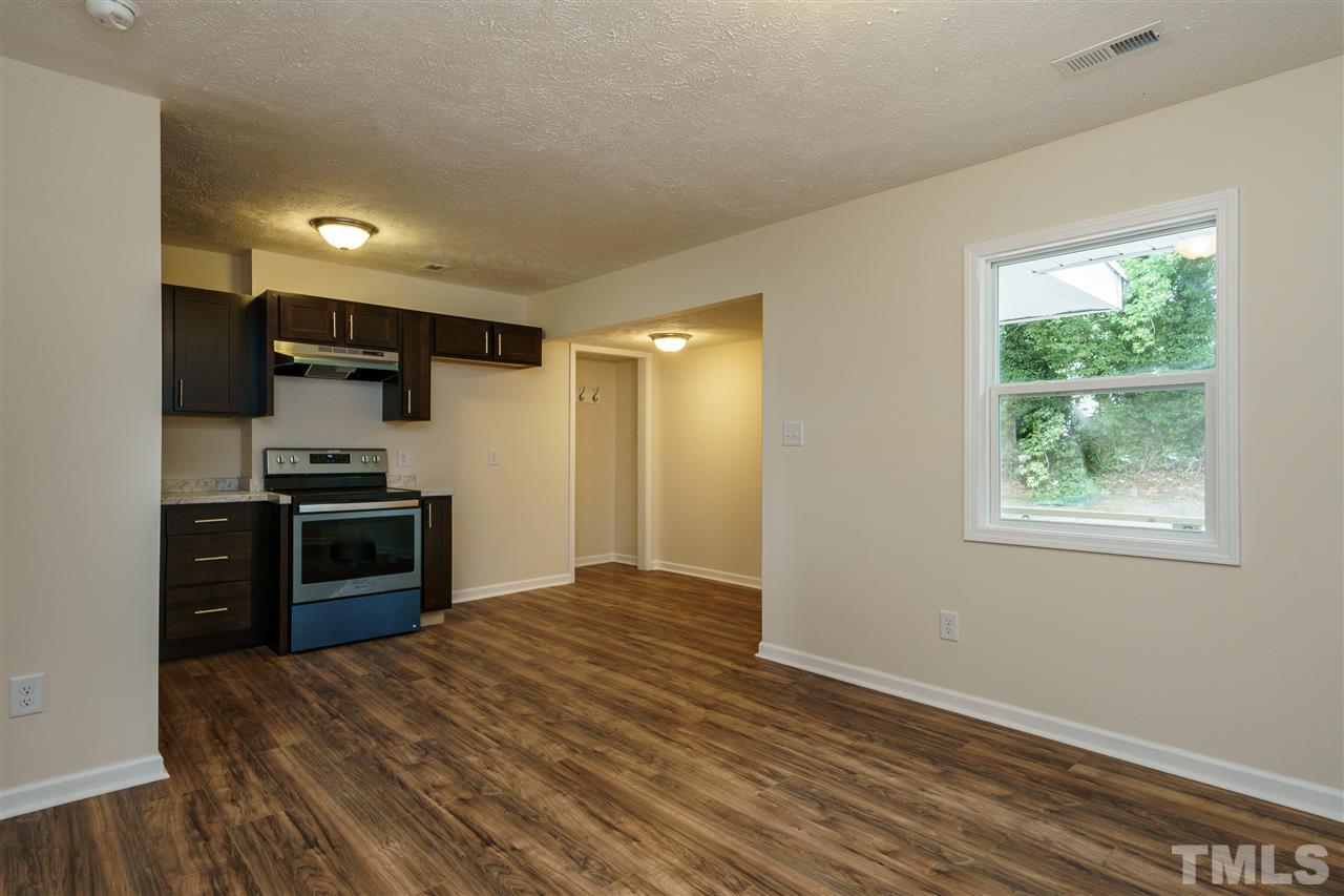 1421 Creech Road Garner, NC 27529 - Photo 18 of 23 a kitchen with granite countertop a stove and a refrigerator