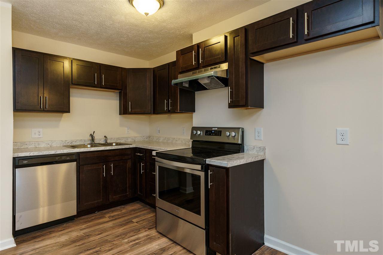 1421 Creech Road Garner, NC 27529 - Photo 20 of 23 a kitchen with stainless steel appliances granite countertop a stove and a sink