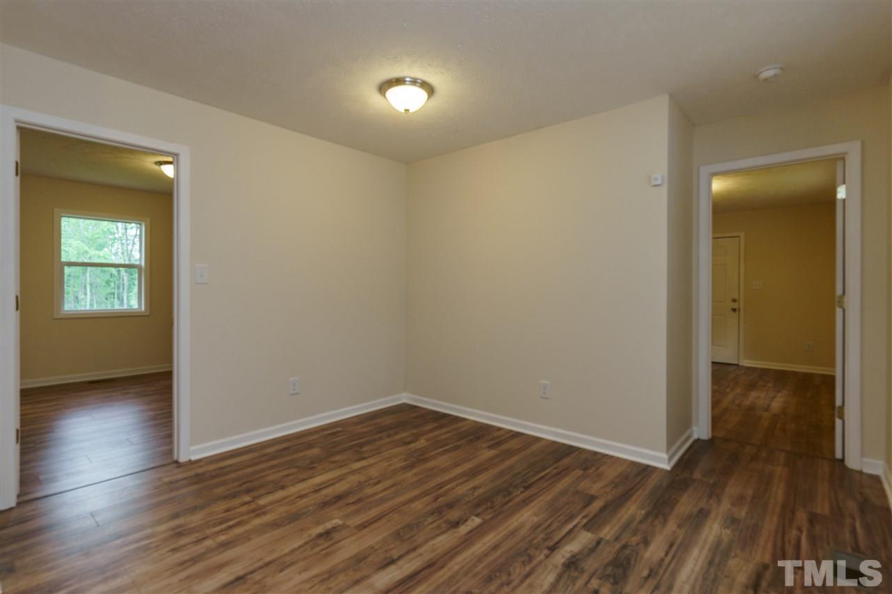 1421 Creech Road Garner, NC 27529 - Photo 5 of 23 an empty room with wooden floor and windows
