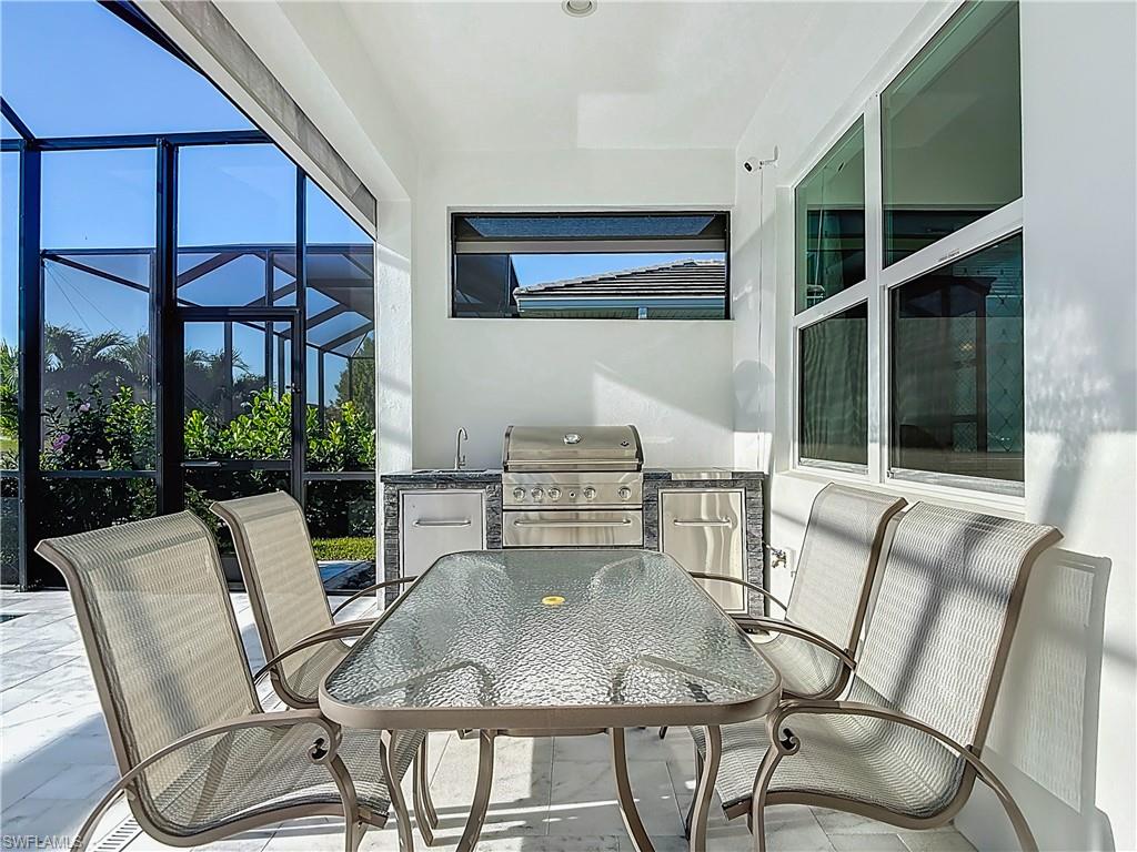 8980 Mustique Lane Naples, FL 34114 - Photo 13 of 50 View of patio with a lanai, outdoor dining area and a grill