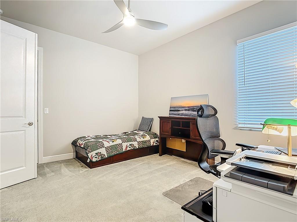 8980 Mustique Lane Naples, FL 34114 - Photo 26 of 50 Bedroom featuring light carpet, ceiling fan, and an office area