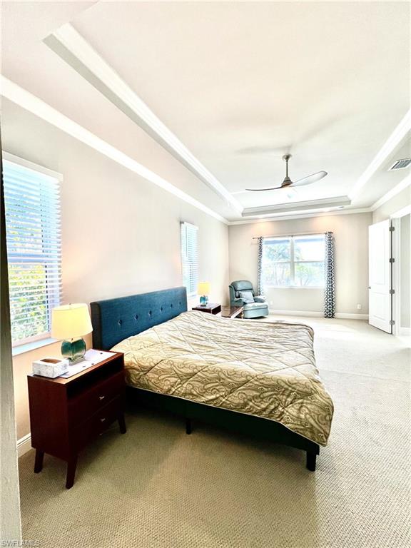 8980 Mustique Lane Naples, FL 34114 - Photo 32 of 50 Bedroom featuring a raised ceiling, carpet, and a ceiling fan