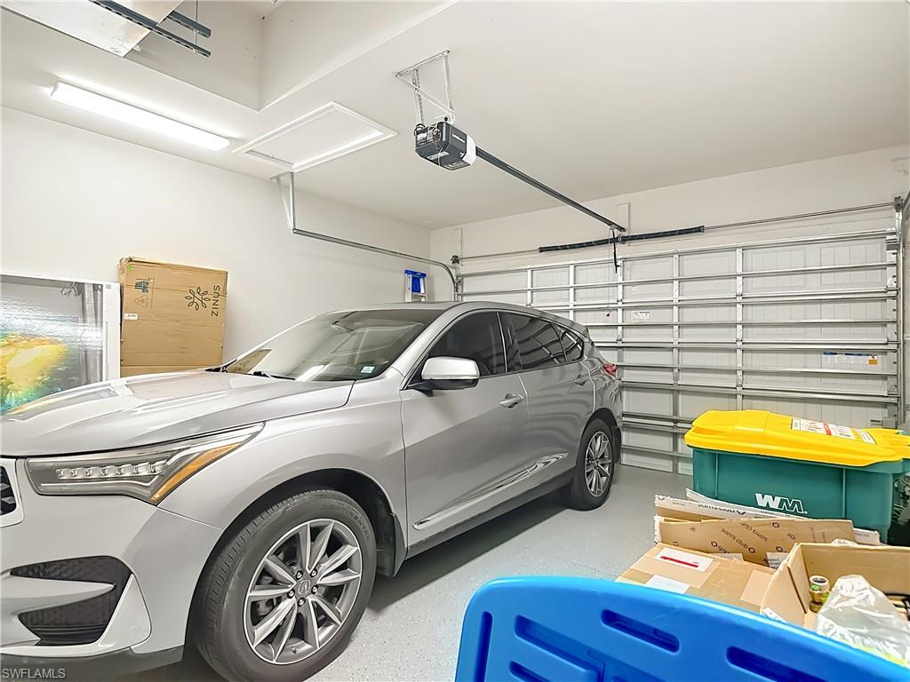 8980 Mustique Lane Naples, FL 34114 - Photo 35 of 50 Garage with a garage door opener