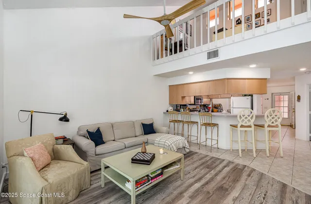 a living room with furniture and a table with kitchen view
