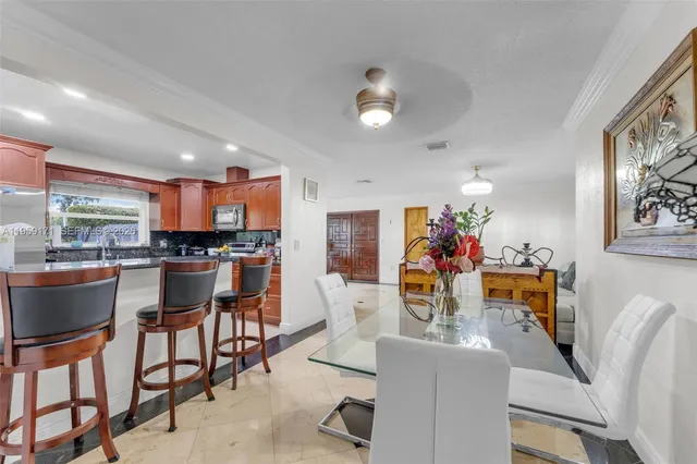 a view of a dining room with furniture and a chandelier
