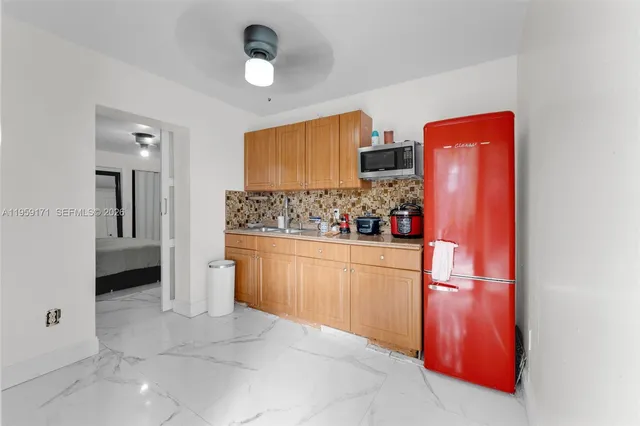 a kitchen with stainless steel appliances granite countertop a refrigerator and microwave