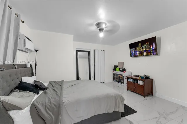 a bedroom with furniture and a flat screen tv