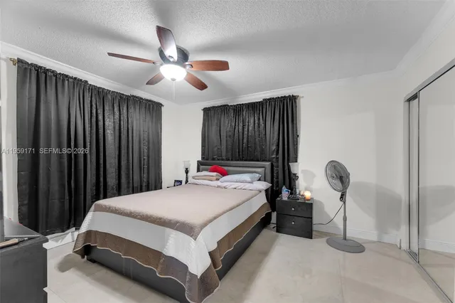 a bedroom with bed and a chandelier