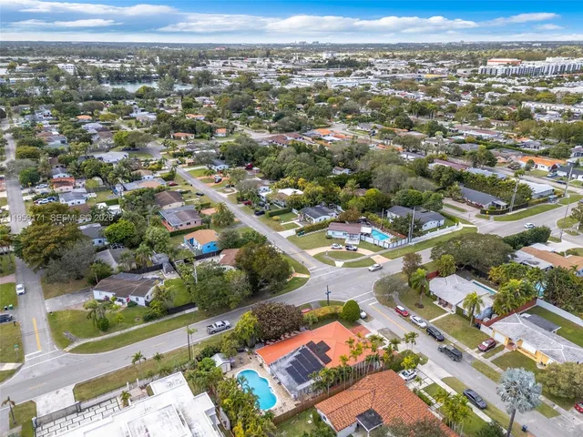 an aerial view of residential building with yard