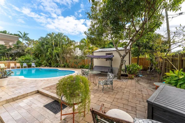 a view of a backyard with sitting area