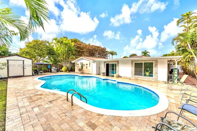 a view of a swimming pool with a patio