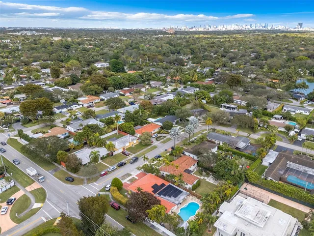 an aerial view of residential houses with city view