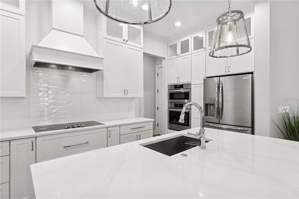 4013 Red Rock Lane Sarasota, FL 34231 - Photo 14 of 60 a kitchen with stainless steel appliances kitchen island a refrigerator sink and cabinets