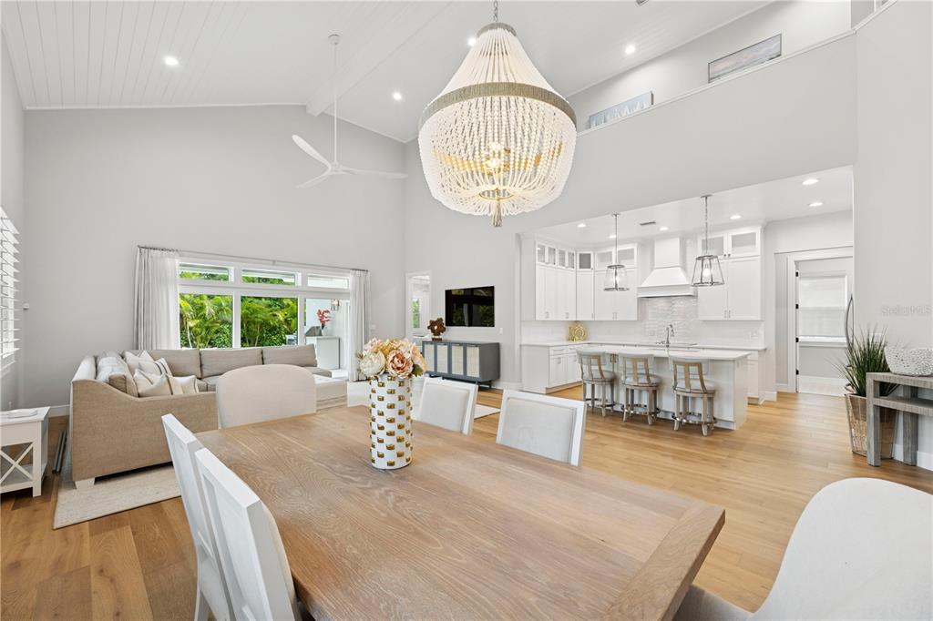 4013 Red Rock Lane Sarasota, FL 34231 - Photo 21 of 60 a living room with furniture chandelier and a large window