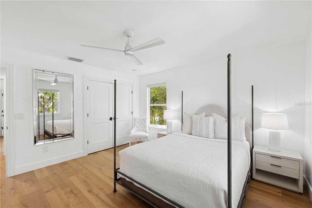 4013 Red Rock Lane Sarasota, FL 34231 - Photo 37 of 60 a bedroom with a bed and a chandelier